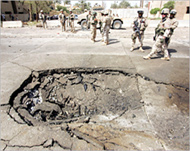 Craters caused by explosives nowpockmark many Baghdad streets