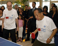 Shalom (L) and Li engaged in talks and a game of table tennis