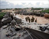 Israeli soldiers and their tanksare massing along Gaza border