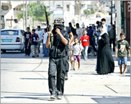 Fatah militants members patrol in Gaza after clashes on 19 July