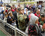 Uzbek refugees flee to Kyrgyzstan in May (File picture) 