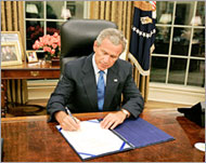 President George Bush signs a $10.5 billion bill for storm relief 