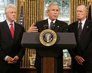 Bush (C) asked  his father (R) andClinton to help raise funds for aid  