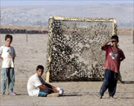 Boys take a break on Friday at a refugee camp near Tal Afar