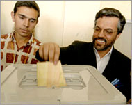 Legislative candidate Yunus Qanuni (R) votes in Kabul