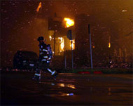 A firefighter battles a blaze in Galveston, Texas, after Rita hit
