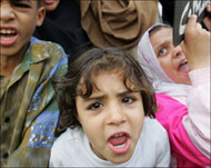 Women and children take part in a protest against Hosni Mubarak