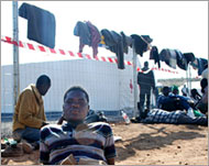 Immigrants lie exhausted after crossing the Morocco-Melilla fence