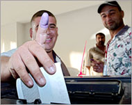 Iraqis' fingers are marked with ink as proof of voting  