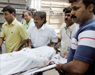 Family members carry the body of a victim of the Paharganj blast