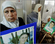 Israeli-Arab women hold portraits of relatives slain in clashes in 2000