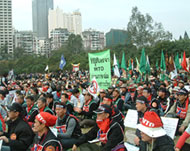 Thousands of demonstrators sit outside the talks
