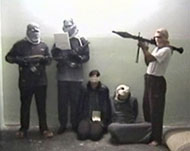 Osthoff (3rd R) sits with her driver in her captors' video 