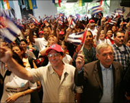 People wave Cuban flags duringa meeting of the Social Forum  