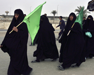 Pilgrims walk along a road from Hilla to Kerbala on Saturday