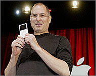 Steve Jobs - seen with an iPod -is co-founder of Apple Computer