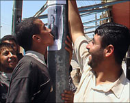 A man kisses a poster of SaddamHussein in Samarra on Friday