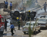 Firefighters douse the fire in a US Humvee  in central Baghdad 