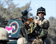 An Iraqi soldier mans his gun inthe Kadhimiya area of Baghdad