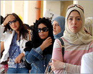 Women queue at a polling station in Kuwait City to vote 