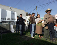 Voters line up at a polling station in San Salvador Atenco