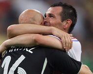 Willy Sagnol (r) embraces Fabian Barthez after their semi-final win