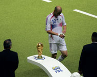 Walk of shame: Zinedine Zidane passes the World Cup trophy