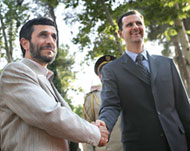 Iran's President Ahmadinejad (L) and Bashar Al-Assad in 2005