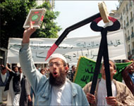 An Islamist holds a Quran at a rally in Algiers in May 1991