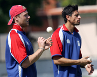 England's Andrew Flintoff (L) and Sajid Mahmood at training in India