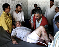 A wounded Iraqi elder is rushedto hospital