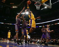 Lakers' Maurice Evans (C) goes up for a dunk against the Suns