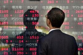 Japan businessman checks stock prices
