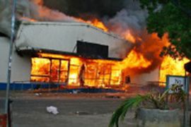 Tonga riots burning shop