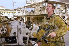 Australian soldier Private Scott Brown surveying the damage to the commercial centre of Nuku' alofa, Tonga