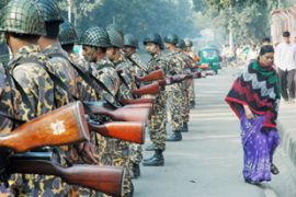 Bangladeshi security personnel stand guard