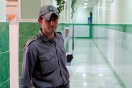 A guard standing in a corridor in Iran's Evin Prison