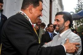 Venezuelan President Hugo Chavez (L) welcomes Iranian President Mahmoud Ahmadinejad