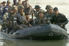 Marines in full battle gear patrol a waterway after joining police in a raid on a suspected terrorist hideout in Taytay town, east of the Philippine capital Manila, 01 February 2007