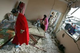 Algerian women check their damaged house