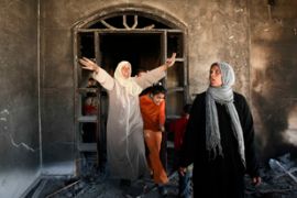 A Palestinian woman shouts inside her destroyed house after clashes between Hamas and Fatah groups in the northern Gaza strip March 11, 2007
