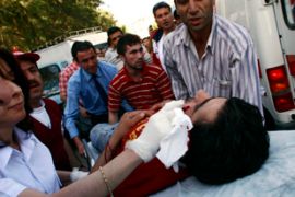 An injured man is carried into a waiting ambulance, Izmir, Turkey