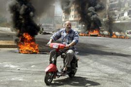 Palestinian man drives past protests