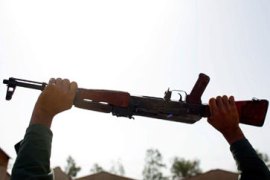 Iraqi raises his weapon