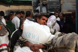 Palestinian carries sacks of flour