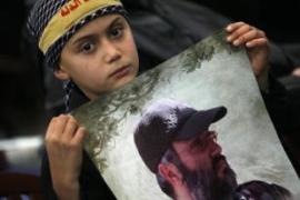 child holds mohagniyeh poster