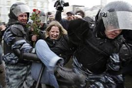 Russian riot police detain an activist against Medvedev presidential victory