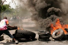haiti port au prince protests rice food price rises tyres
