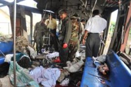 Sri Lankan security officials examine the scene of a bomb blast train