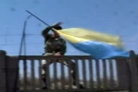Russian troops pulling down Ukraine flag